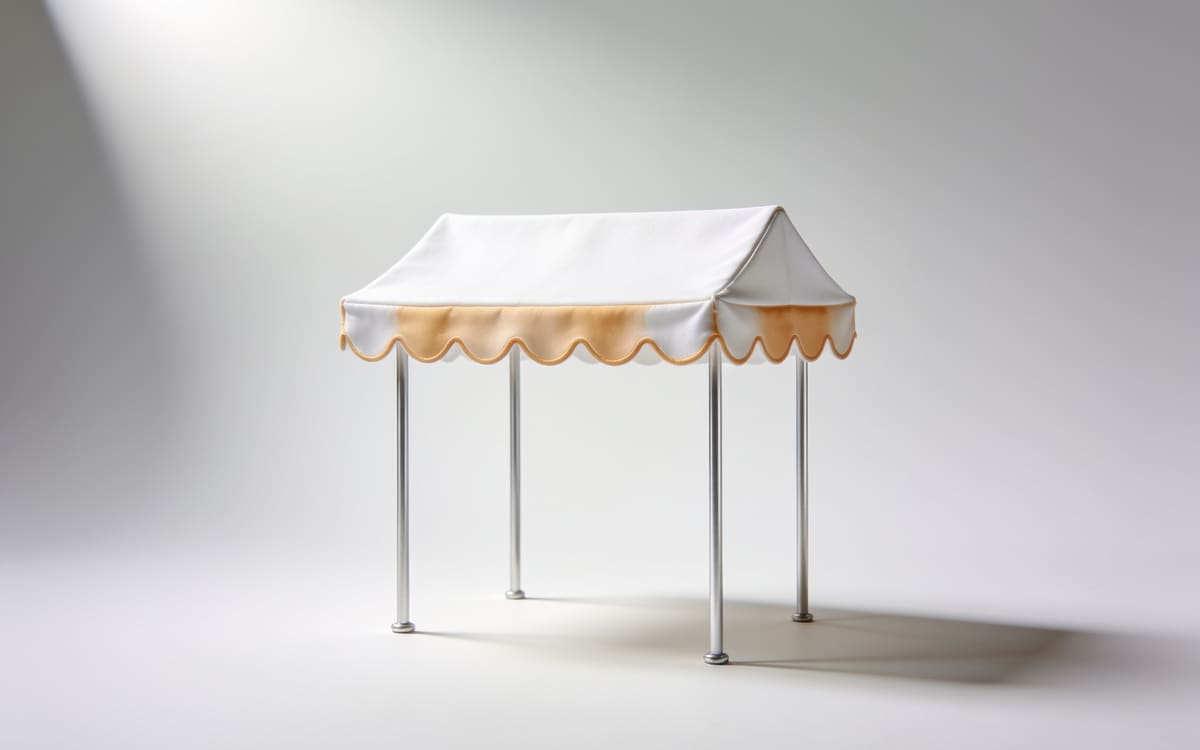 An abstract festival stall canopy with a scalloped awning on slender poles on a light grey studio background